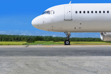 White jet airplane on runway and blue sky
