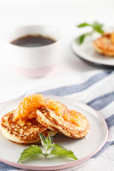 Cottage cheese pancakes, syrniki, curd fritters. Breakfast with coffee, cheesecake and apricot jam. copyspace