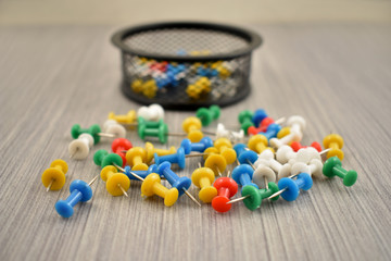 Color pins stock images. Tack on a wooden background. Multicolor plastic tacks. Set of color pins