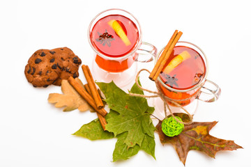 Autumn drink concept. Mulled wine or hot beverage in wineglasses with cinnamon sticks. Glasses with...