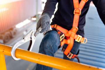 Construction worker use safety harness and safety line working on a new construction site...