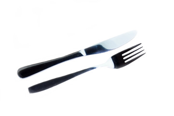 Metal fork and knife on a white background viewed from above