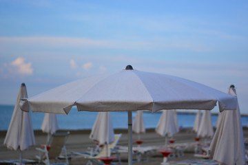 Fototapeta na wymiar An open white beach umbrella