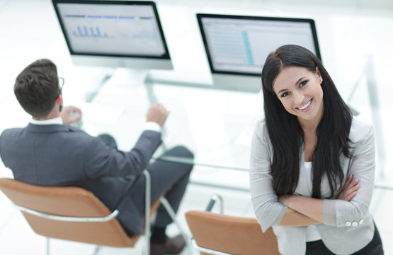 successful business woman standing near modern workplace