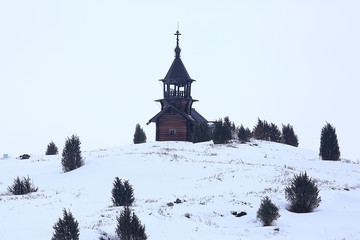 lonely wooden church in the field / concept faith, god, loneliness, architecture in the winter landscape