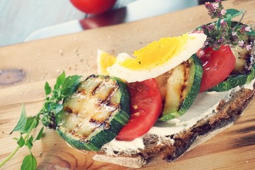 taste experience. summer vegetables. zucchini and tomato. a cooked egg. fast healthy breakfast