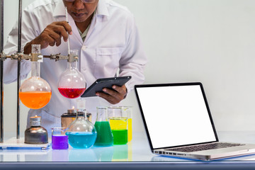 a scientist work on computer in chemical mixing in laboratory experiments with copy space