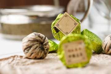 Chinese natural round shape tea packed in green aluminum foil, selective focus