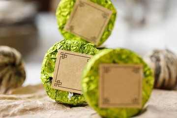 Chinese natural round shape tea packed in green aluminum foil, selective focus, macro