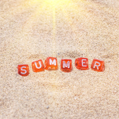 Fototapeta na wymiar Summer Travel. Concept with word SUMMER of cubes on beach sand