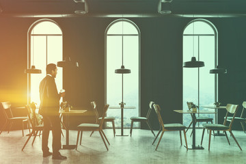 African American man in a loft cafe interior