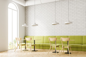 Loft white brick restaurant corner, green sofa