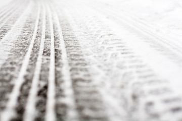 Wheel tracks on the road covered with snow