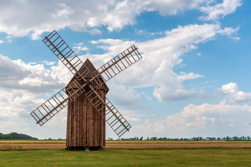 Fototapeta premium Traditional wooden windmill on field in Poland.