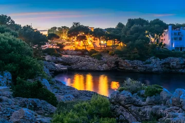 Foto op Plexiglas Night scene in Cala Dor region of Mallorca. Sea coast Punta Grosa illuminated by light in evening, © cristianbalate