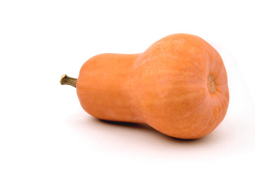 pumpkin in the shape of a pear lies on its side on a white background, close-up