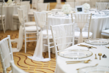 White chairs setup for luxury wedding party celebration, The wedding reception dinner table setting