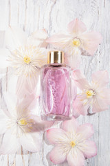 Obraz na płótnie Canvas Perfume bottles and white flowers