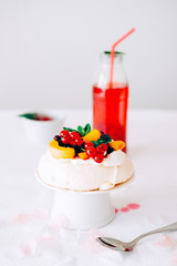 Tasty Pavlova dessert with white meringue, cream and fruit