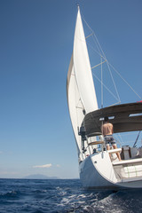 Fototapeta premium Man sailing toward an island in Croatia. Among the many beautiful islands of Croatia. Hvar, Brac, Vis, Korčula. 