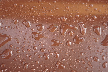 drops of water on a brown surface
