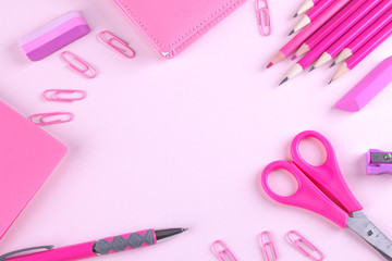 Various stationery in one color scheme on a bright paper pink background. Top view