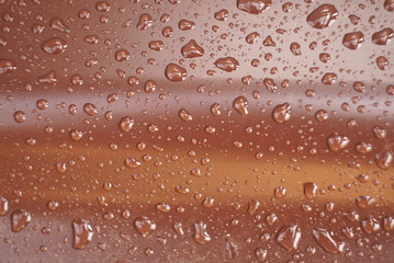 drops of water on a brown surface