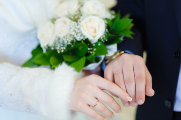 Obraz na płótnie Canvas Wedding couple holding hands. Wedding bouquet in hands of bride.