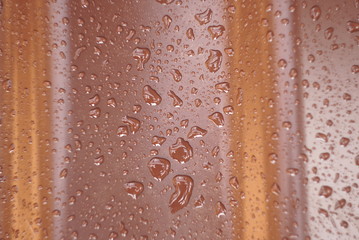 drops of water on a brown surface