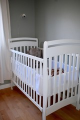 Baby crib with plush toys for infant play and napping
