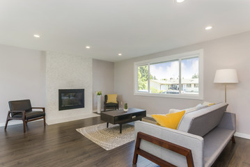 Simple yet elegant living room with stone fireplace.