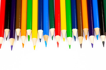 Color pencils lined up in a row against a white background.