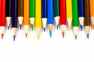 Color pencils lined up in a row against a white background.
