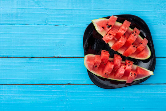Fresh slices of watermelon on a blue background