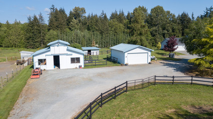 Fototapeta na wymiar Drone view of the farm yard with barn, garage.