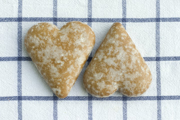 Two gingerbread cookies in the form heart.