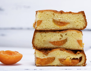a stack of baked square slices of a biscuit pie with apricots