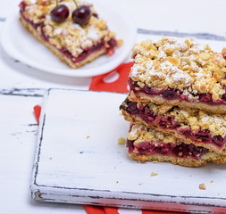stack of baked slices of a pie with cherry berries