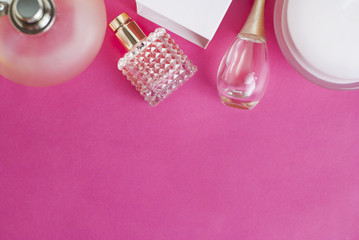 Perfume Women Parfume Bottles on Pink Background, Gift, Fragrance, Perfumery and Cosmetics. Copy space for Text.