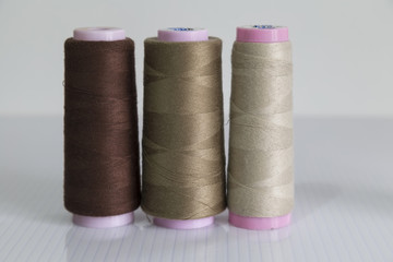 colorful bobbin on the white background for textile concept.