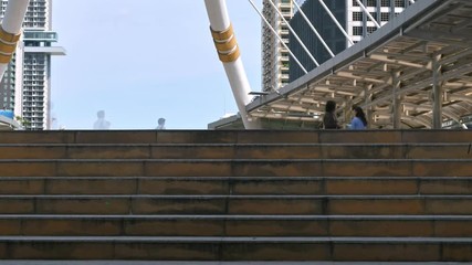 Time lapse of moving business people on the street of urban city with blue sky in background. Finance concept.