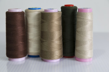 colorful bobbin on the white background for textile concept.