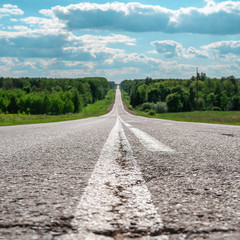 Minimalistic landscape of asphalt road in the cracks of the distant horizon
