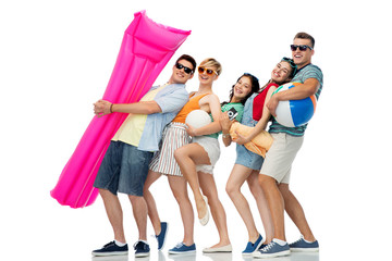 summer holidays and people concept - group of happy smiling friends in sunglasses with beach ball, volleyball, towel, camera and air mattress over white background