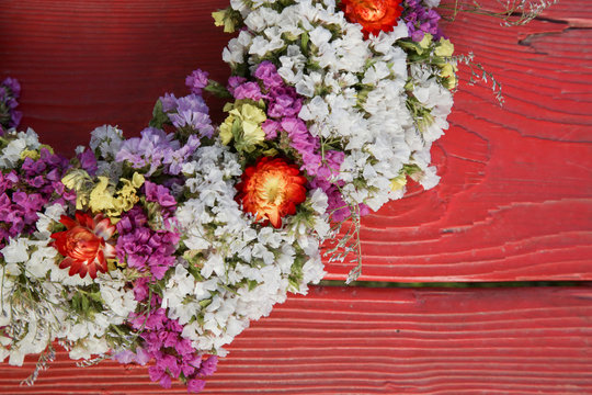 Beautiful flower wreath or flower crown on the obsolate red wooden planks