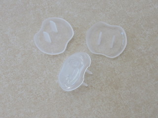 White outlet safety covers to protect babies and children from electrocution 