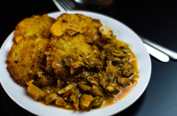 potato pancakes with spicy stew, delicious traditional dish, Hungarian cuisine