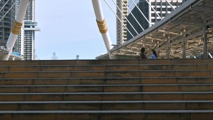 Time lapse of moving business people on the street of urban city with blue sky in background. Finance concept.