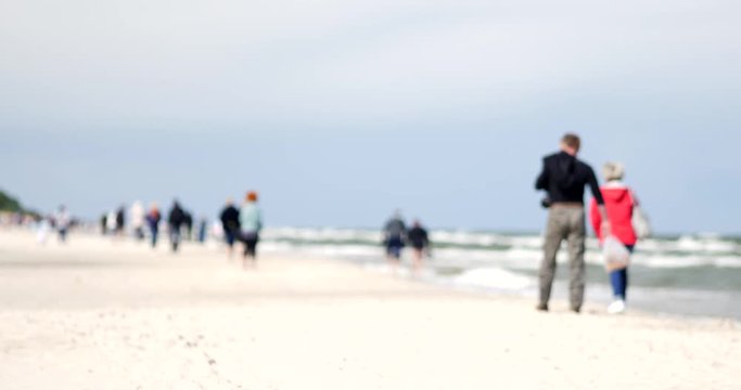 Unrecognizable people resting on the beach of Baltic Sea.