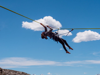 Fototapeta na wymiar Girl hanging from highline in the Colorado mountains